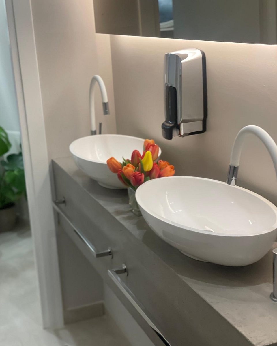 As built: twin basins on a grey stone counter with tulips between them.